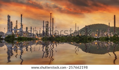 Oil refinery at twilight - petrochemical industry with water reflect.