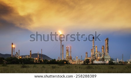 Big Industrial oil tanks in a refinery with treatment pond at industrial plants.