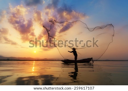Fisherman of Bangpra Lake in action when fishing, Thailand.