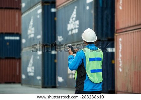 Tablet to handle export and import goods prepare the delivery of rubber compactos in port.