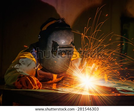 Worker welding the steel part by manual