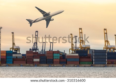 Industrial Container Cargo freight ship with working crane bridge in shipyard at dusk for Logistic Import Export background