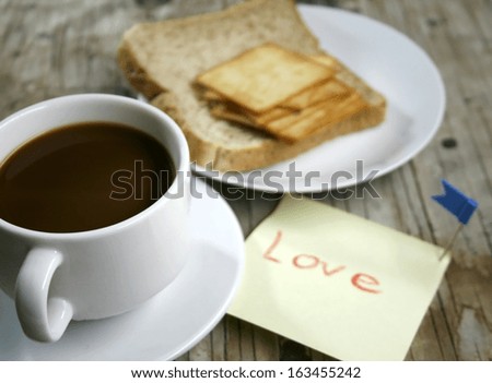 plate with a cup of coffee and bread