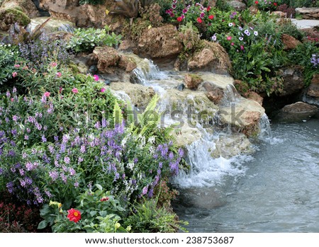 Flowers and waterfall in indoor garden