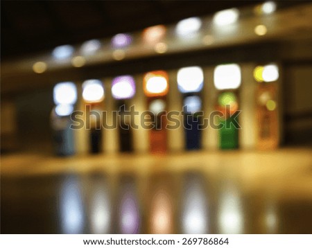 Abstract blurry automatic teller machine or ATM in dim light building