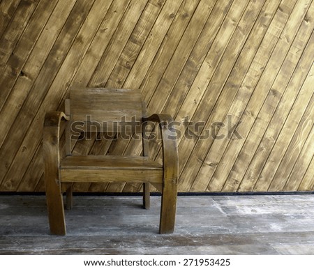 wooden chair on the in front of the wall wood