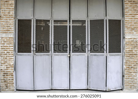 old steel sheets door with iron net