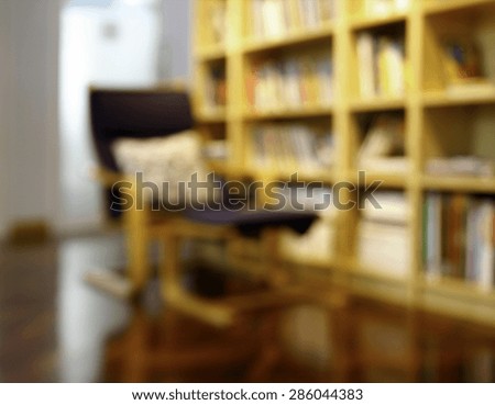 Blurred books on the shelf in public library. Blurred effect. Background for your pictures