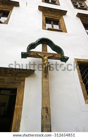 Stone crucifix at the entrance to the house