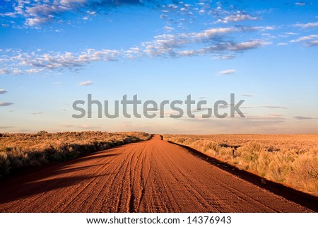 desolate road to horizon with deep blue sky