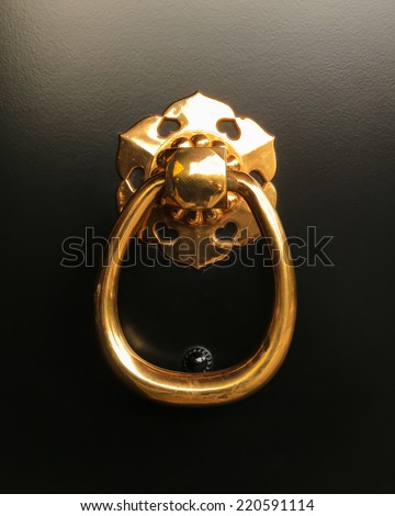 Gold Ring Pull Handle on Black Door