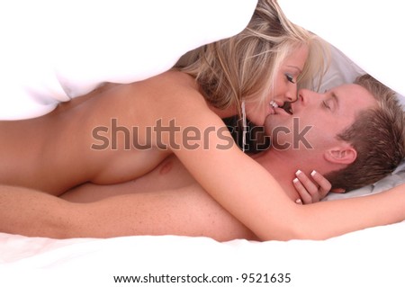 stock photo intimate couple in bed under white sheet engaged in steamy