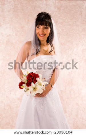 bride in wedding dress and bouquet standing half body front view