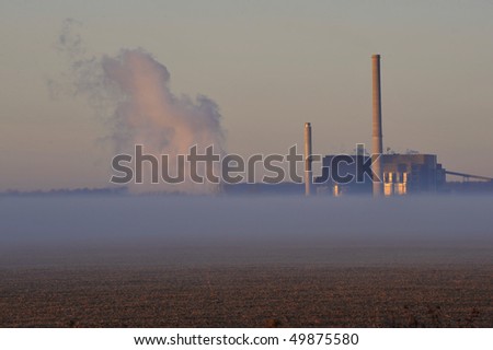 smoke from an industrial plant in the midwest with ground fog in the foreground