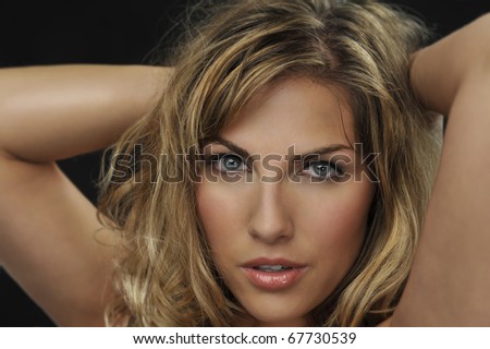beautiful blond woman head shot in sensual pose
