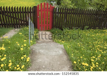 Brown wooden fence and a red gate