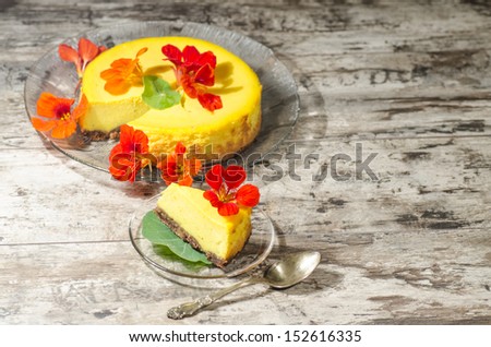 Pumpkin cheesecake decorated with fresh flowers. From the series \