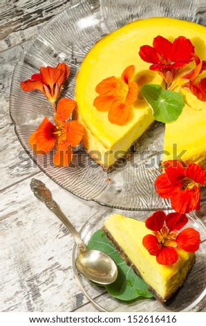 Pumpkin cheesecake decorated with fresh flowers. From the series \