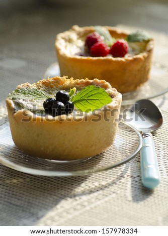 Mini berry tarts decorated with raspberries and blueberries