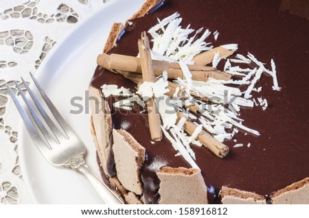 French chocolate cake covered with mirror chocolate icing . From the series \