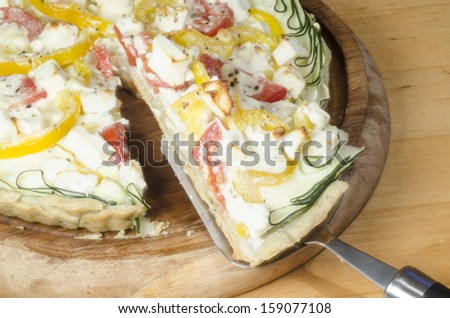 Ready vegetable pie on wooden cutting board. From series \