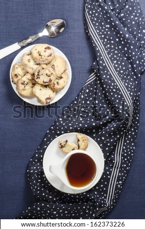 Porcelain dishes and cookies with cranberries. From series Playing with Color