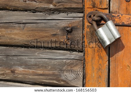 Old wooden door with padlock,  fragment. From series backgrounds and textures