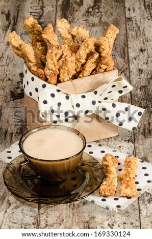 Garlic cheese bread sticks and cup of black tea with milk From series Homemade bread