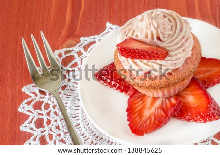 Strawberry cupcake with butter cream decorated with slices of fresh strawberries From series Summer desserts