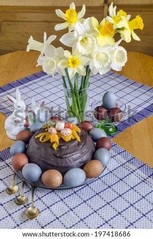 Festive Easter table decorated with flowers, colored eggs and cakes From series Food for Easter