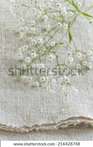 Still life with bouquet flowers on linen tablecloths Overhead view. Selective focus