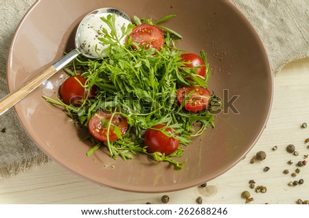 Ingredients for Italian caprese salad with fresh basil leaves, tomato and  mozzarella  on red wooden table. Overhead view. From series Natural organic food