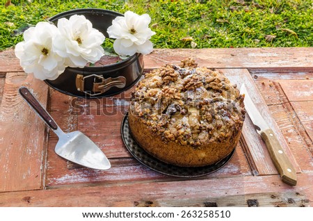 Autumn still life with cake, walnuts and white roses. Rustic style. From series Natural organic food