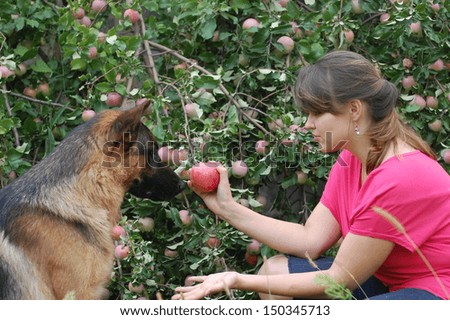 Teen girl  in the garden play with dog.  Near Kiev,Ukraine