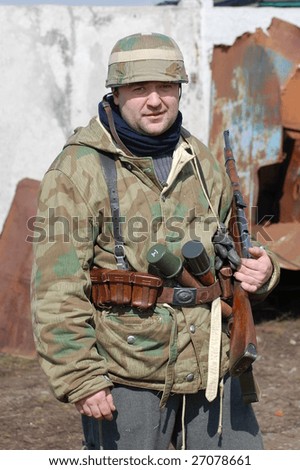 VINNITSA, UKRAINE - MAR 21: A member of a history club called Red Star wears a historical German uniform as he participates in a WWII reenactment in Vinnitsa, Ukraine March 21, 2009.