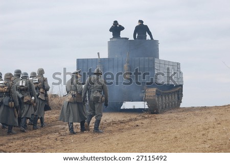 VINNITSA, UKRAINE - MAR 21: Members of history club called Red Star wear historical German uniform on the tank as they participate in a WWII reenactment in Vinnitsa, Ukraine on March 21, 2009.