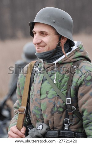 VINNITSA, UKRAINE - MAR 21: Member of a history club called Red Star wears a historical German uniform as he participates in a WWII reenactment in Vinnitsa, Ukraine on March 21, 2009.