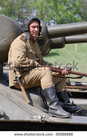 KIEV, UKRAINE - MAY 9: A member of history club called Red Star wears historical Soviet uniform as he participates in a WWII reenactment May 9, 2009 in Kiev, Ukraine.