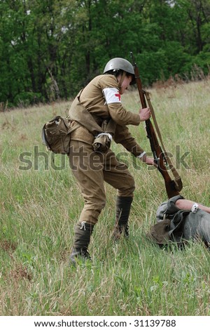 KIEV, UKRAINE - MAY 9: A member of history club called Red Star wears historical Soviet uniform as she participates in a WWII reenactment May 9, 2009 in Kiev, Ukraine