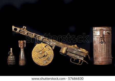 Military archeology.World War II Soviet machine-gun remains and German cannister for gas mask Found with metal detector