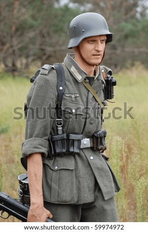 CHERNIGOW, UKRAINE - AUG 29: Member of Red Star military history club wears historical German  uniform during historical reenactment of WWII, August 29, 2010 in Chernigow, Ukraine
