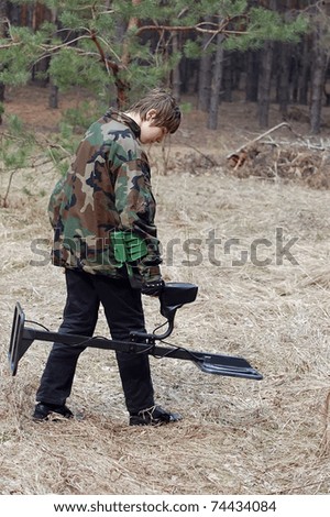 Military archeology. Boy teenager with metal detector on the battlefield of WW2.Ukraine