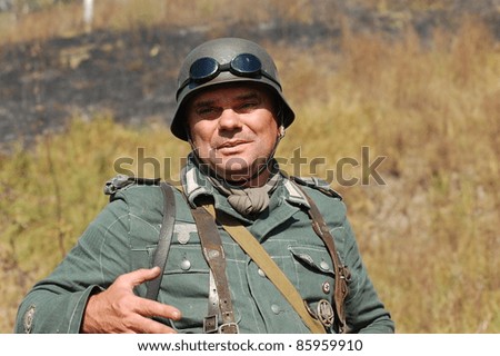 KIEV, UKRAINE -SEPT 18: A member of Red Star history club wears historical German uniform during historical reenactment of WWII, September 18, 2011 in Kiev, Ukraine