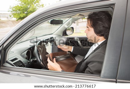 Businessman reviewing documents in the car