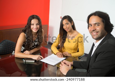 Three executives working at a business meeting