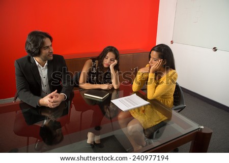 Three executives tired working at a business meeting