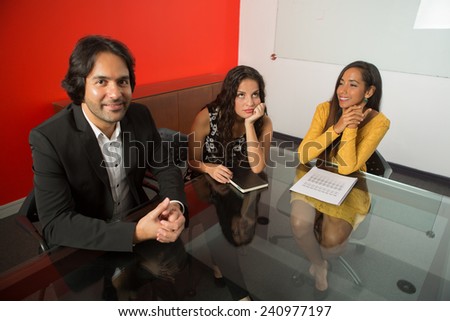 Three executives working at a business meeting one of them bore