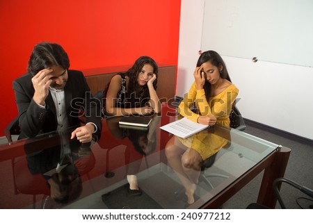 Three executives tired working at a business meeting