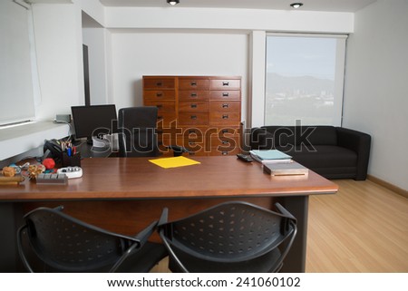 Big empty office with yellow paper on desk