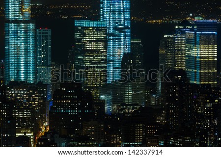 one world trade center and surrounding buildings in new york city at night